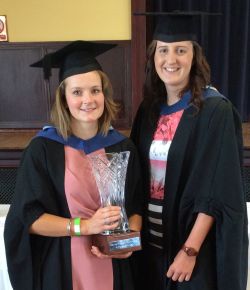 Grace Elizabeth Righton receives her award from Honours Graduate Lauren Johnston.